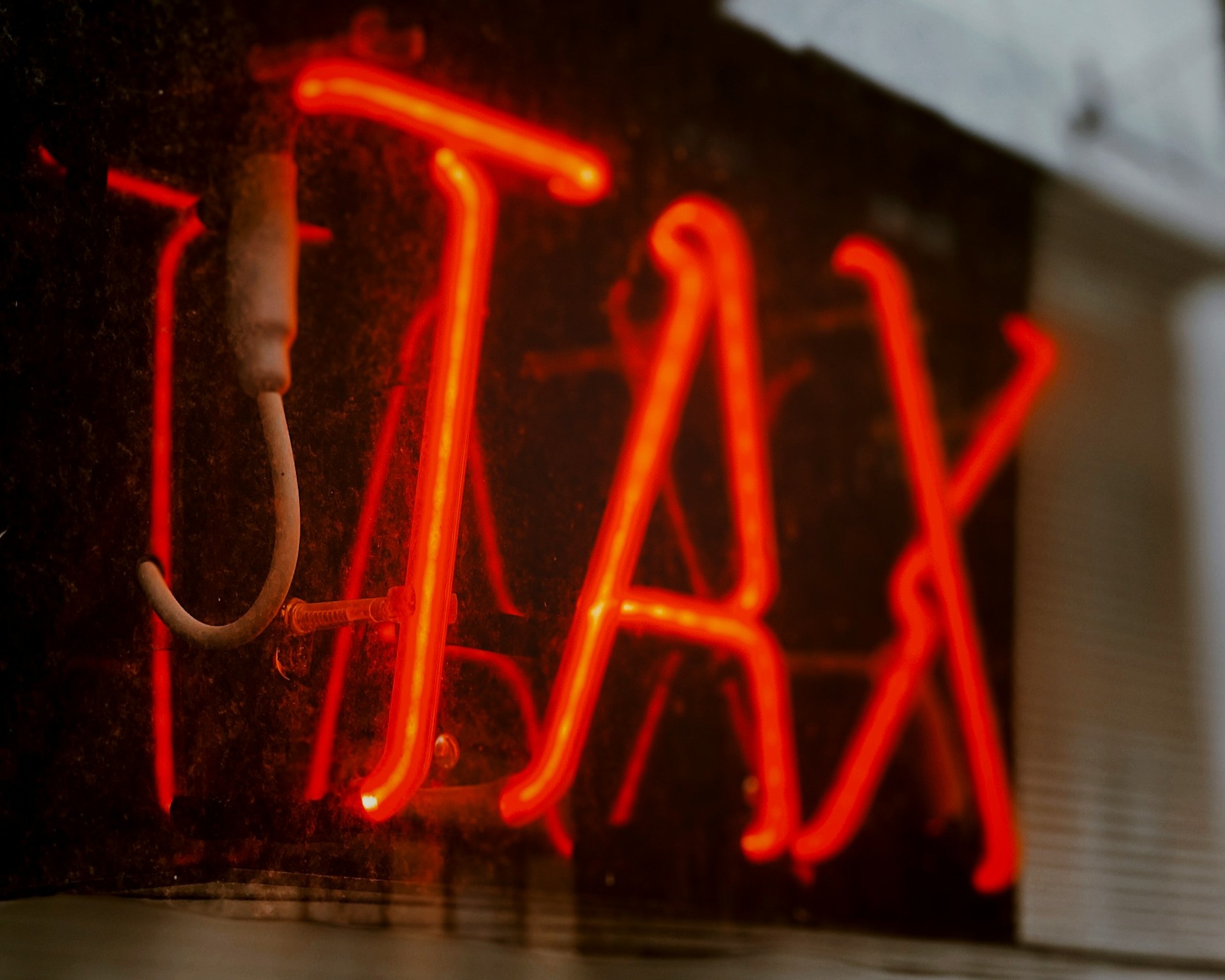 Neon sign that says "TAX"