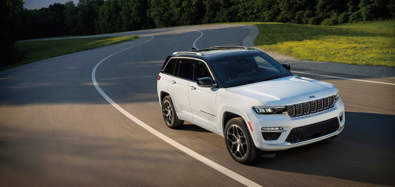 2026 Jeep Grand Cherokee 4xe SUV driving on curving road